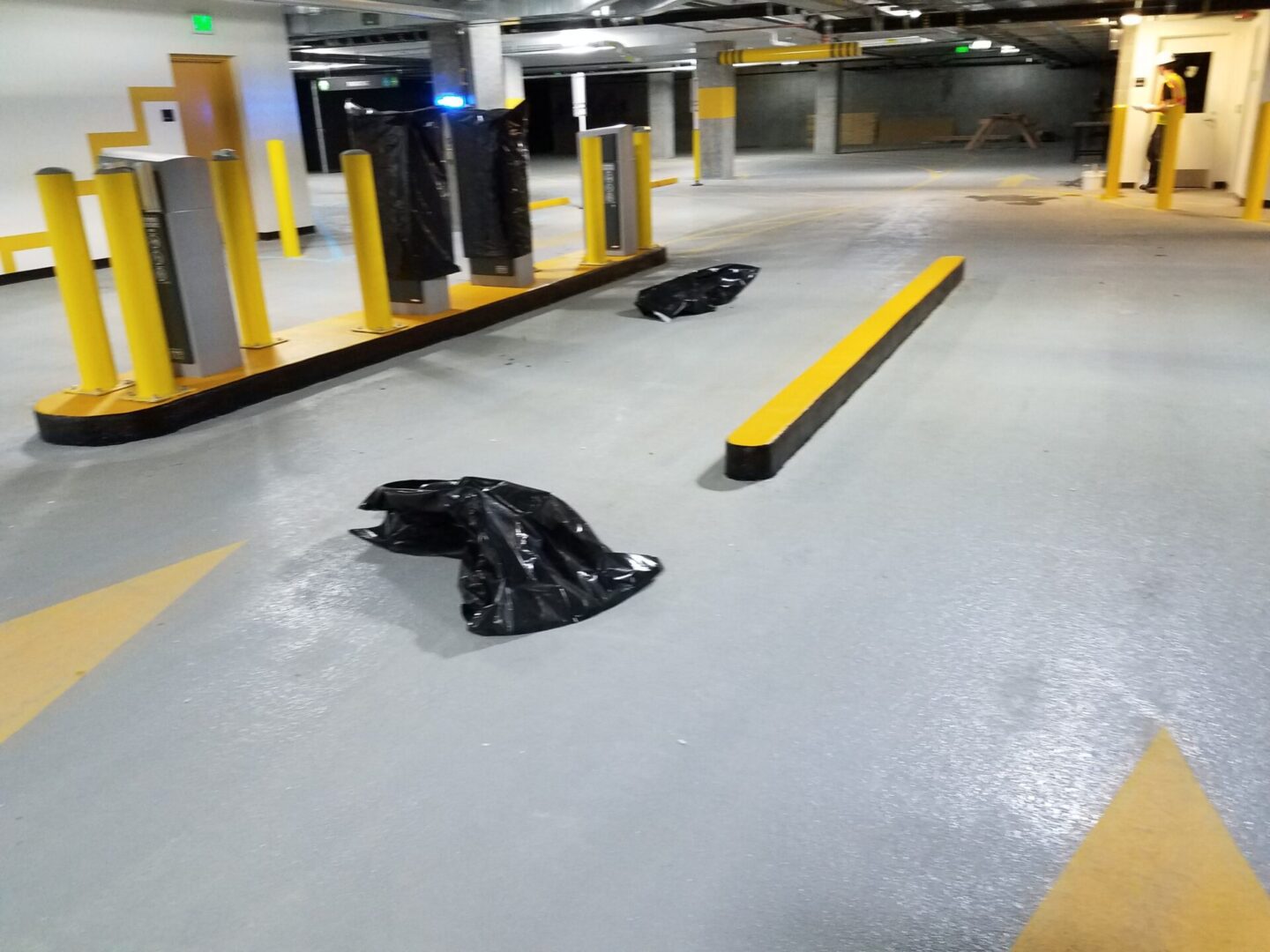 Empty parking garage with yellow safety barriers.
