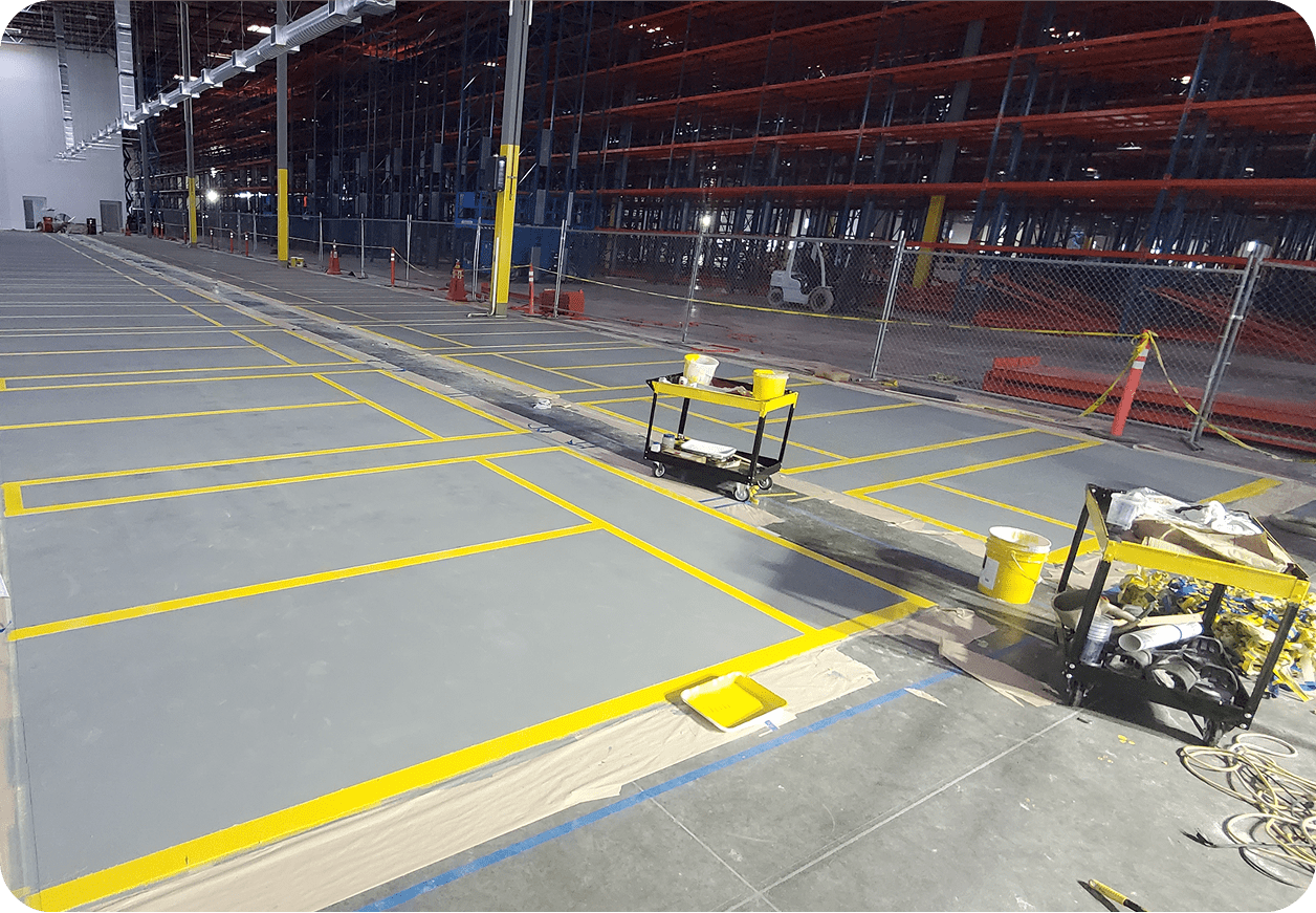 Warehouse floor with freshly painted yellow lines.
