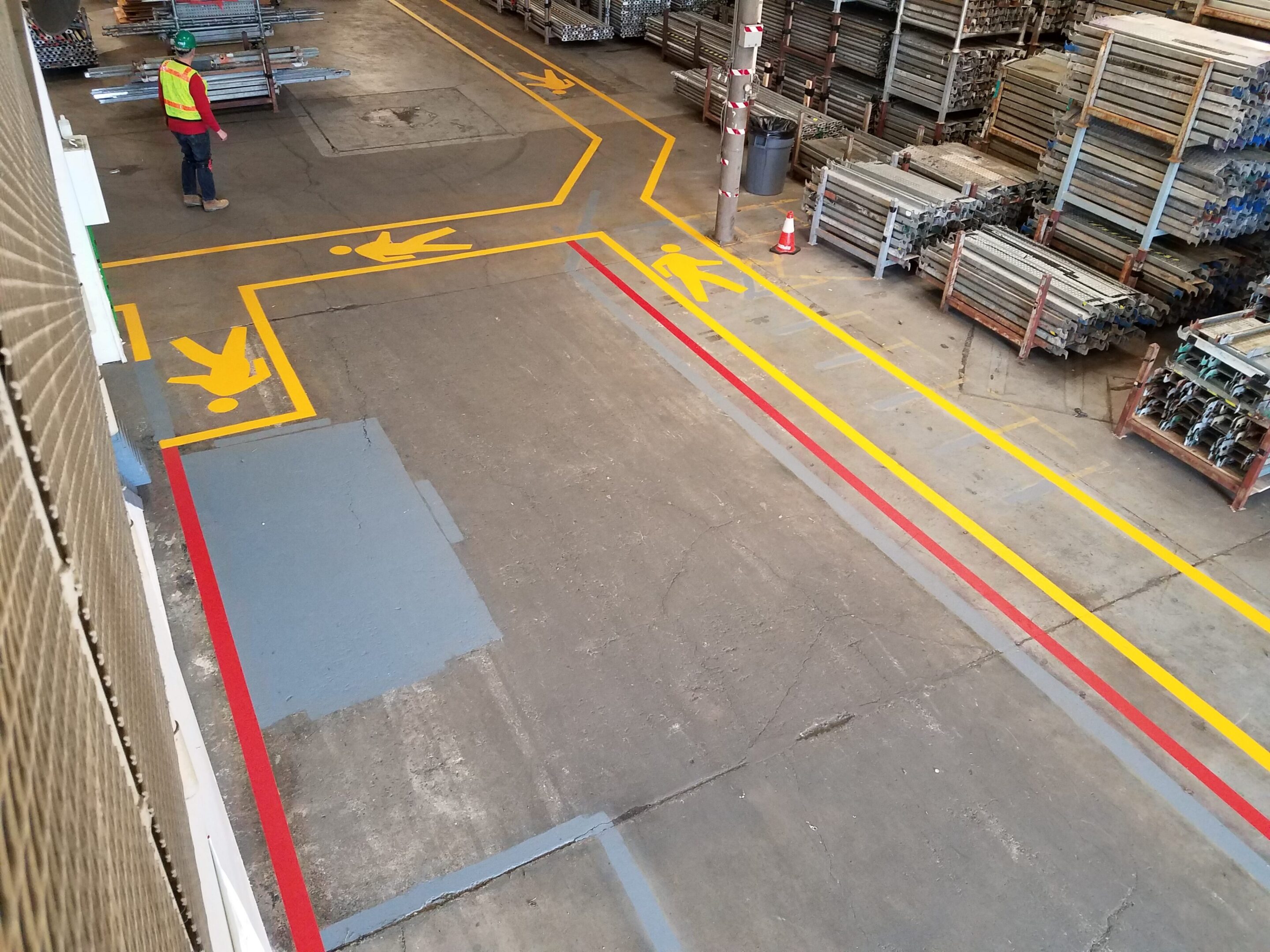 Warehouse floor with marked pathways and storage areas.